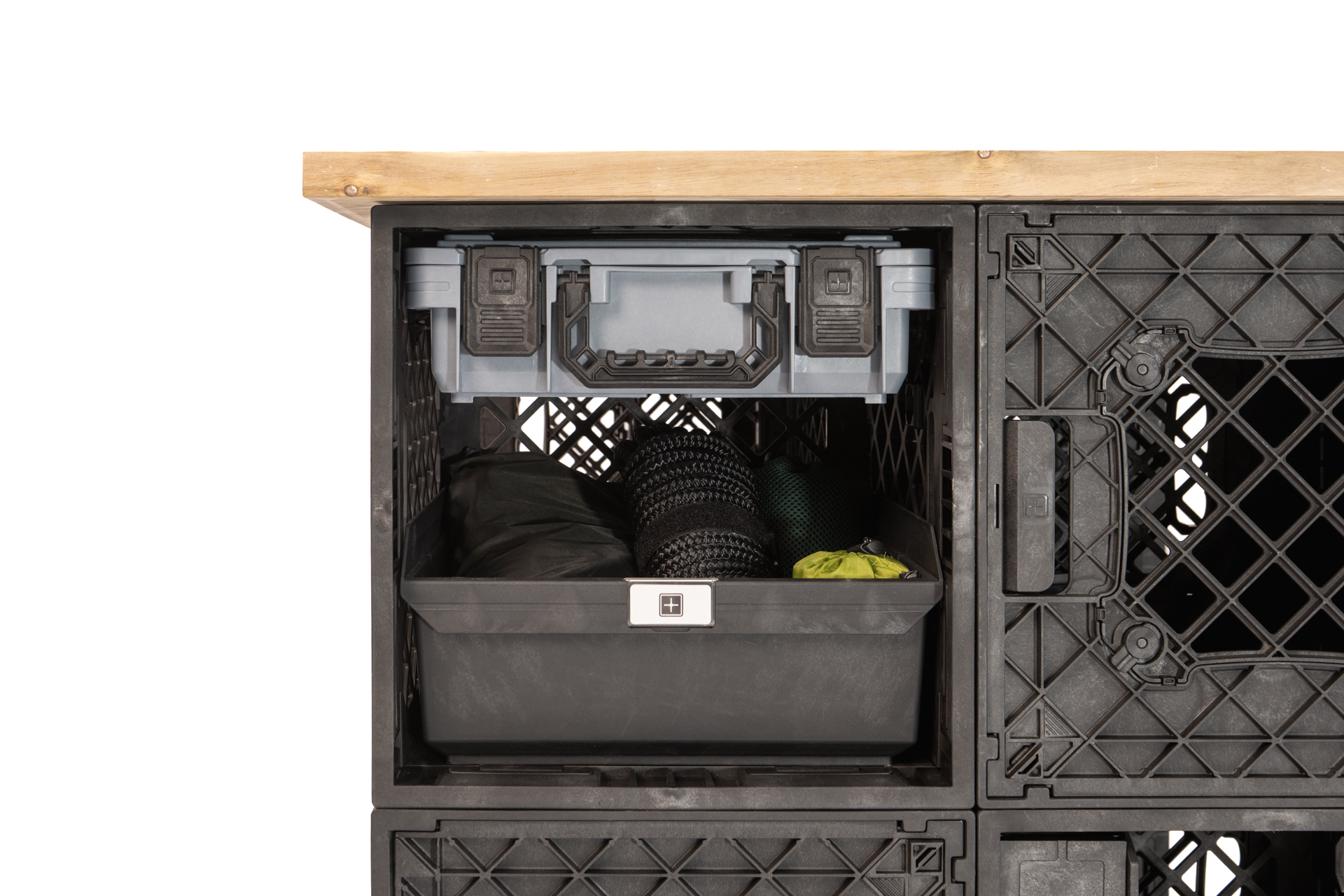 CrateShot Bench Interior Storage Detail A close-up of the CrateShot Bench showing an open UbeCube compartment with a utility box, pull-out bin, and soft gear organized beneath the wood worktop.