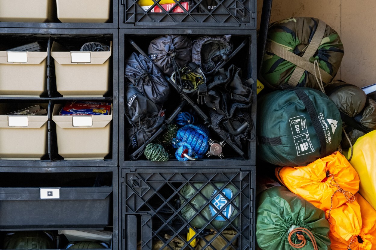 Close-up of camping gear organized inside UbeCube crates with Grab Bins, CrateDividers, ropes, bags, and soft outdoor equipment.