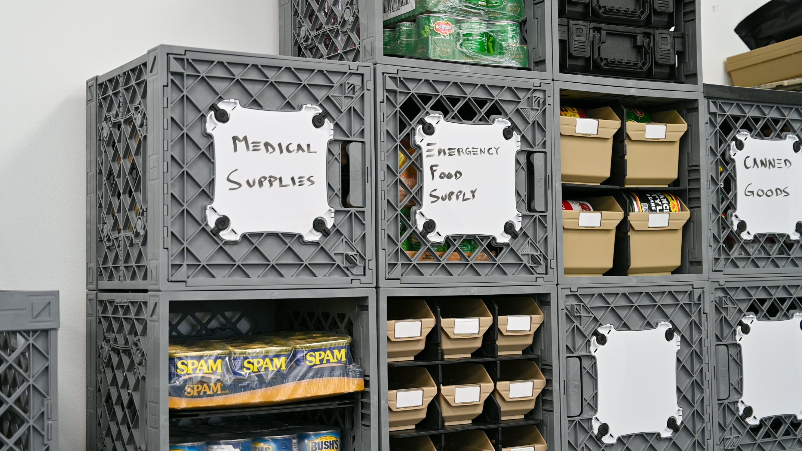 UbeCube&trade; modular prepper storage wall with labeled Whiteboard MOD Panels for medical supplies, emergency food supply, and canned goods.