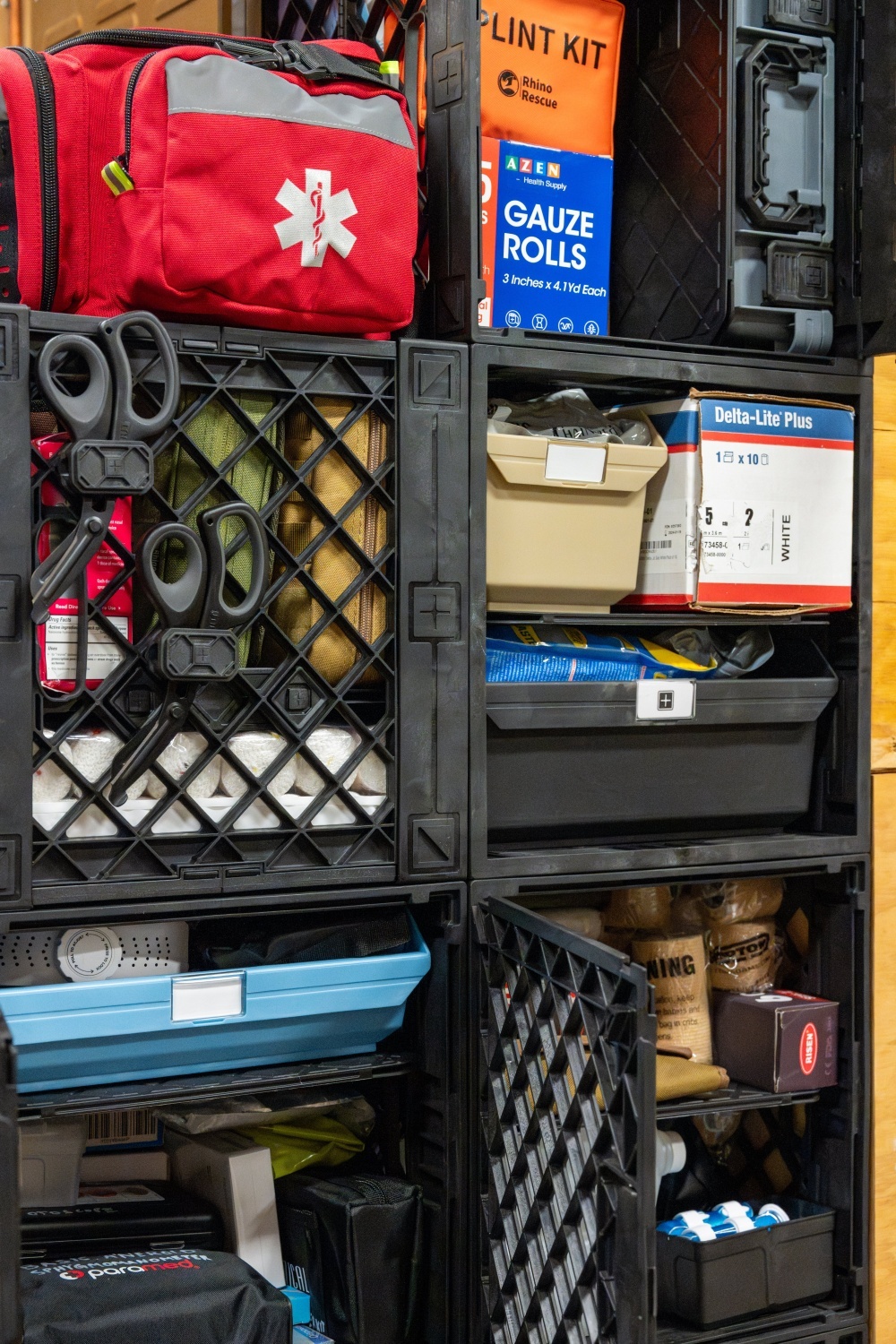 UbeCube&trade; prepper storage tower with medical bags, tools, trays, bins, and emergency supplies organized in connected modular crates.