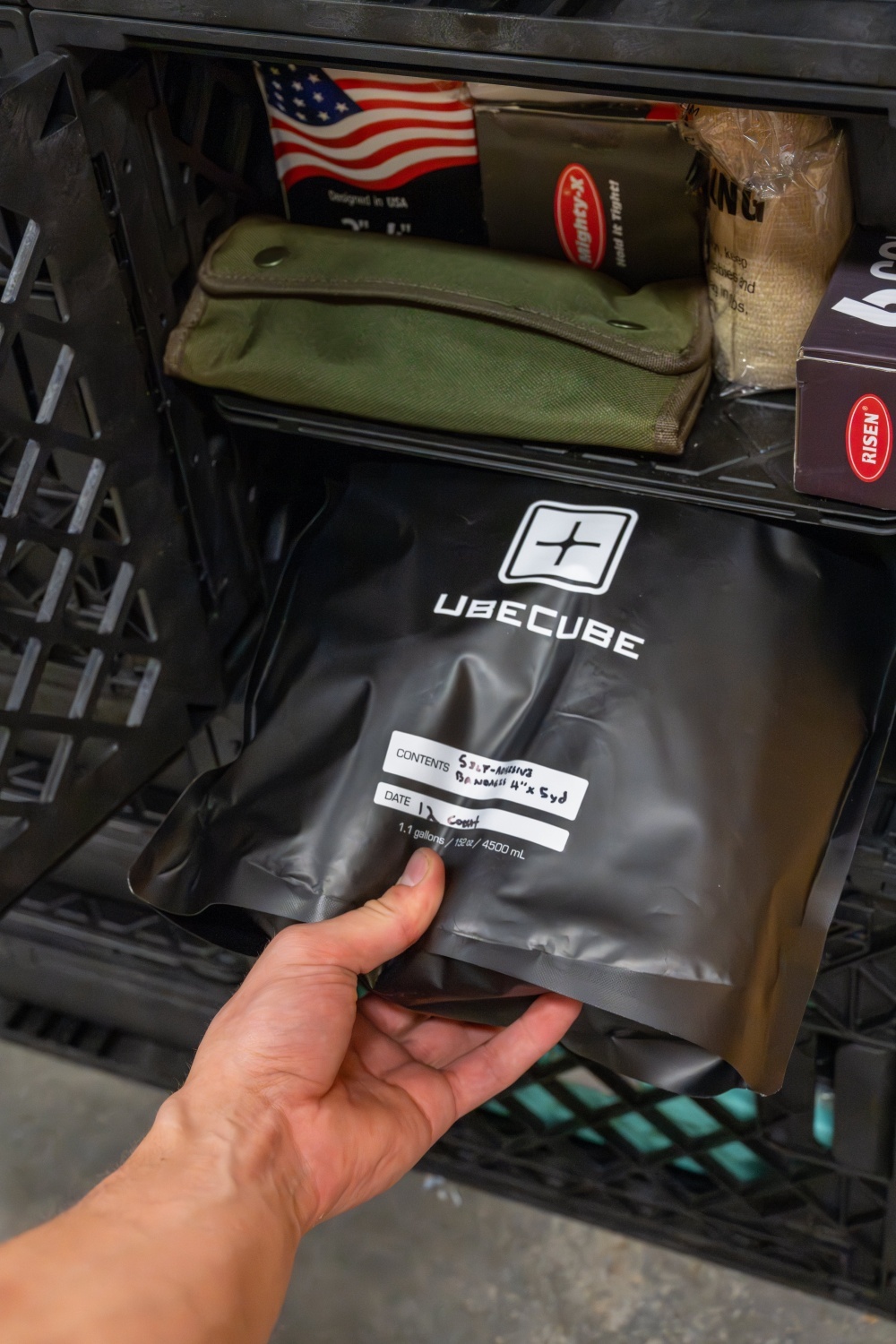UbeCube&trade; Mylar Bag being pulled from a modular prepper storage crate for labeled long term dry food storage.