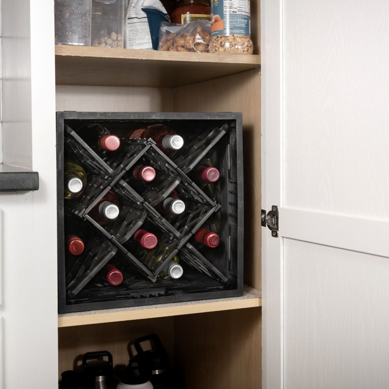 CrateWine&trade; modular wine storage crate placed inside pantry cabinet for compact home organization.